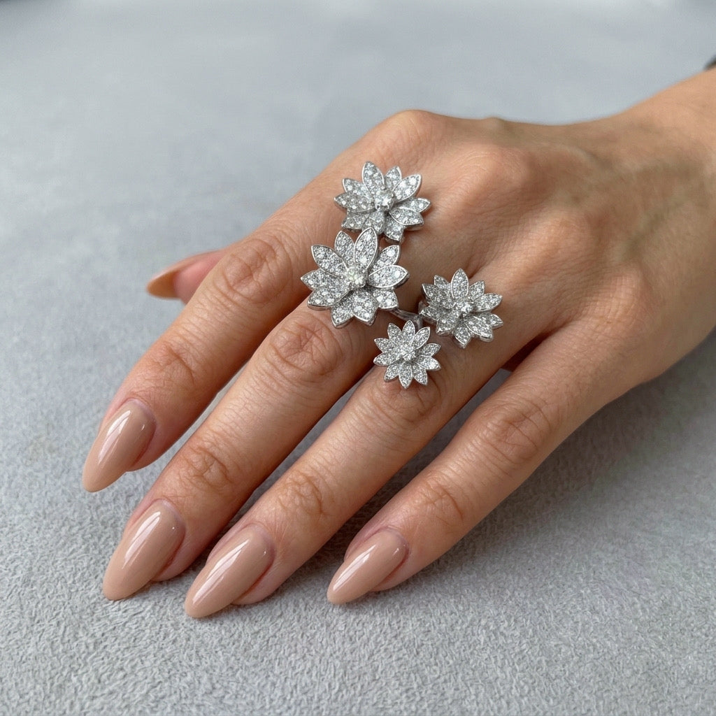 Hand wearing a diamond flower ring on a neutral background - Enchanted Garden Between the Finger Ring - The Songbird Collection