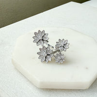 Silver floral earrings on a marble surface - Enchanted Garden Between the Finger Ring - The Songbird Collection