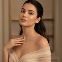 Woman wearing a delicate necklace against a neutral background - Eternal Stars Lariat Necklace - The Songbird Collection