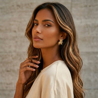Woman with long, wavy hair wearing a white top against a neutral background - Fireworks Statement Earrings - The Songbird Collection