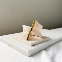 Decorative object with gold accents on a marble surface