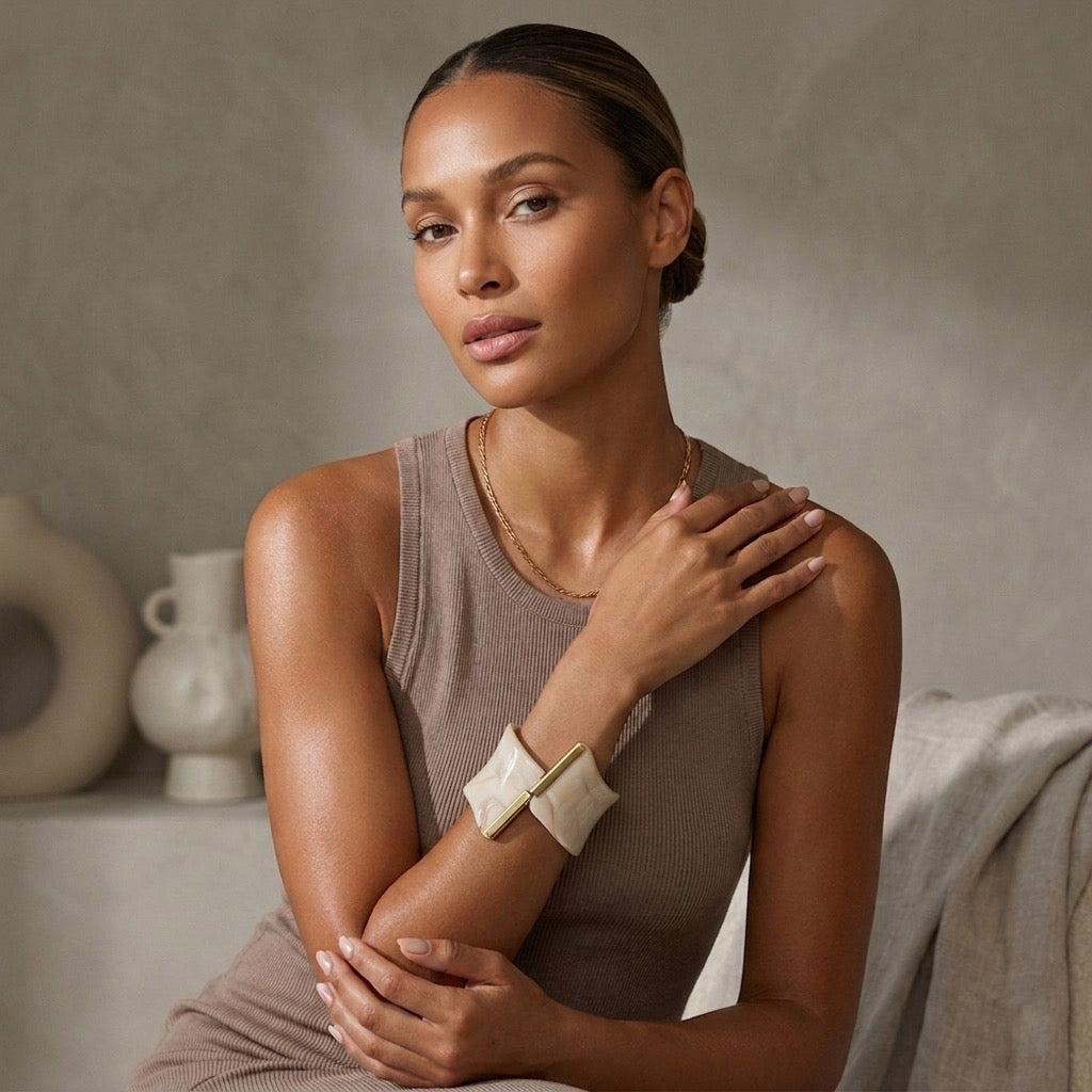 Woman wearing a sleeveless top and beige arm sleeve against a neutral background. Gaia Sculptural Statement Bracelet - The Songbird Collection