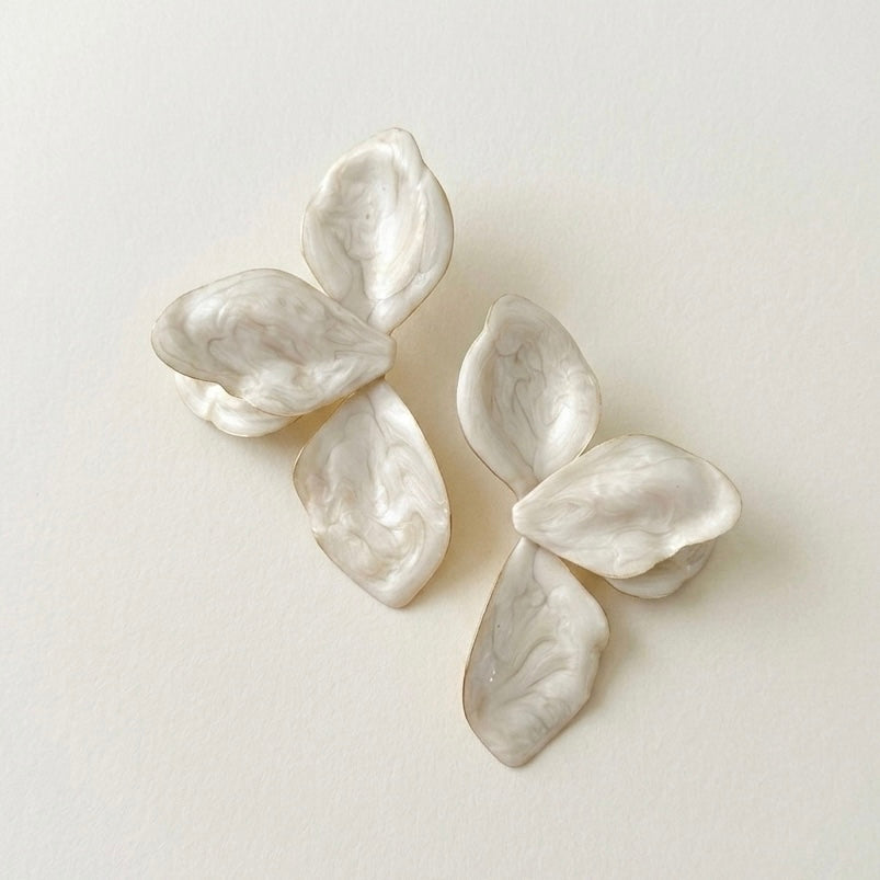 Pair of white floral earrings on a light beige background  Ivory_Lotus_Statement_Earrings_-_The_Songbird_Collection