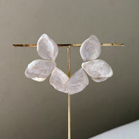 Decorative lamp with marble-like leaves on a gold stand against a neutral background  Ivory_Lotus_Statement_Earrings_-_The_Songbird_Collection