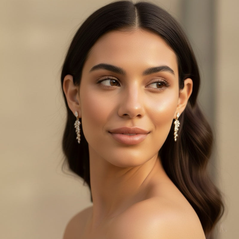 Woman wearing earrings with a neutral background