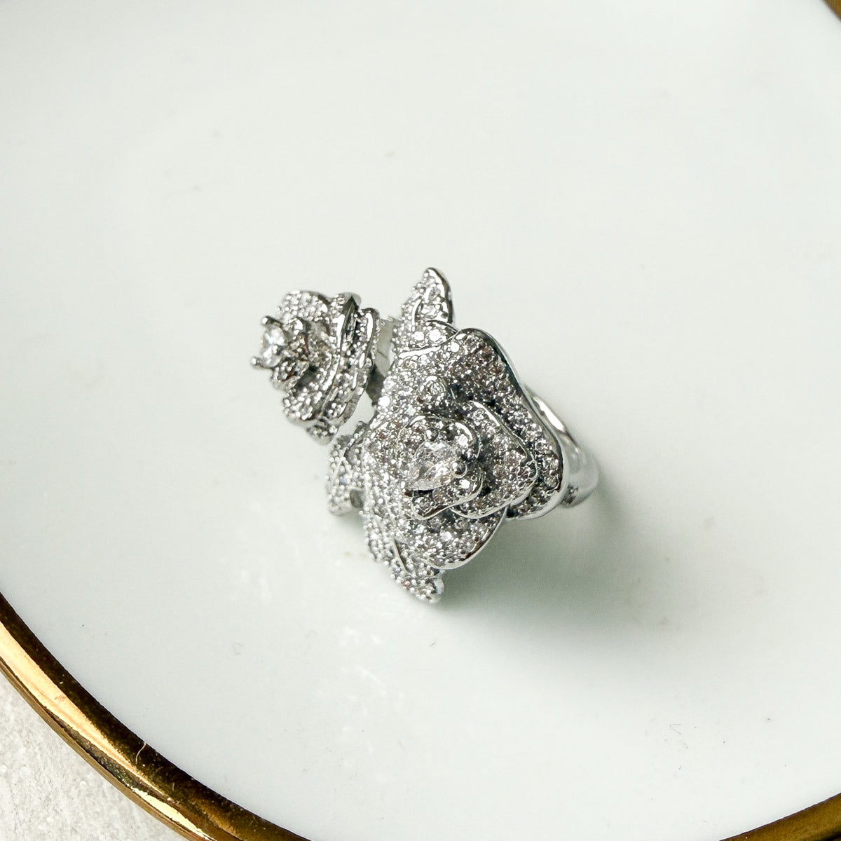 Silver floral earring on a white surface