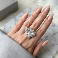 Hand wearing a silver ring with gemstones on a marble surface-L’Harmonie des Roses - The Songbird Collection