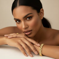 Woman wearing gold jewelry on a neutral background - Lucia Watch Link Chain Bracelet - The Songbird Collection
