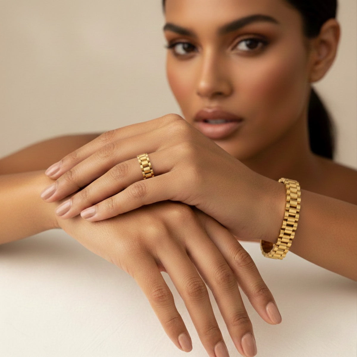 Woman wearing gold ring and bracelet on a neutral background - Lucia Watch Link Chain Bracelet - The Songbird Collection