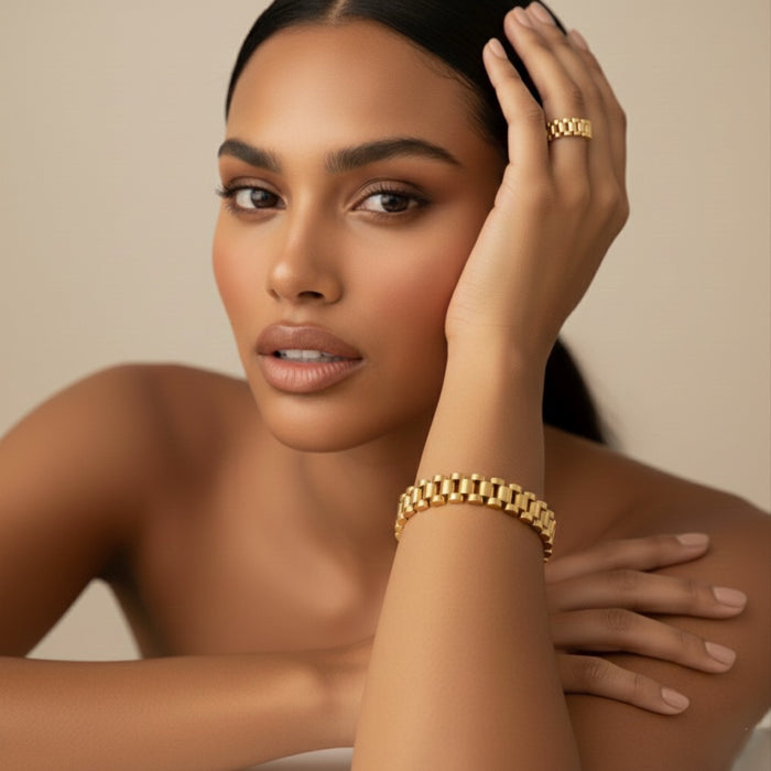 Woman wearing gold jewelry against a neutral background - Lucia Watch Link Chain Bracelet - The Songbird Collection