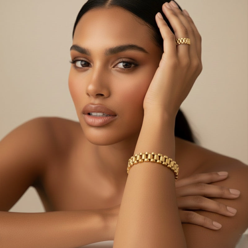 Woman wearing gold jewelry against a neutral background - Lucia Watch Link Chain Bracelet - The Songbird Collection