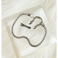Silver chain with clasp on a light fabric background