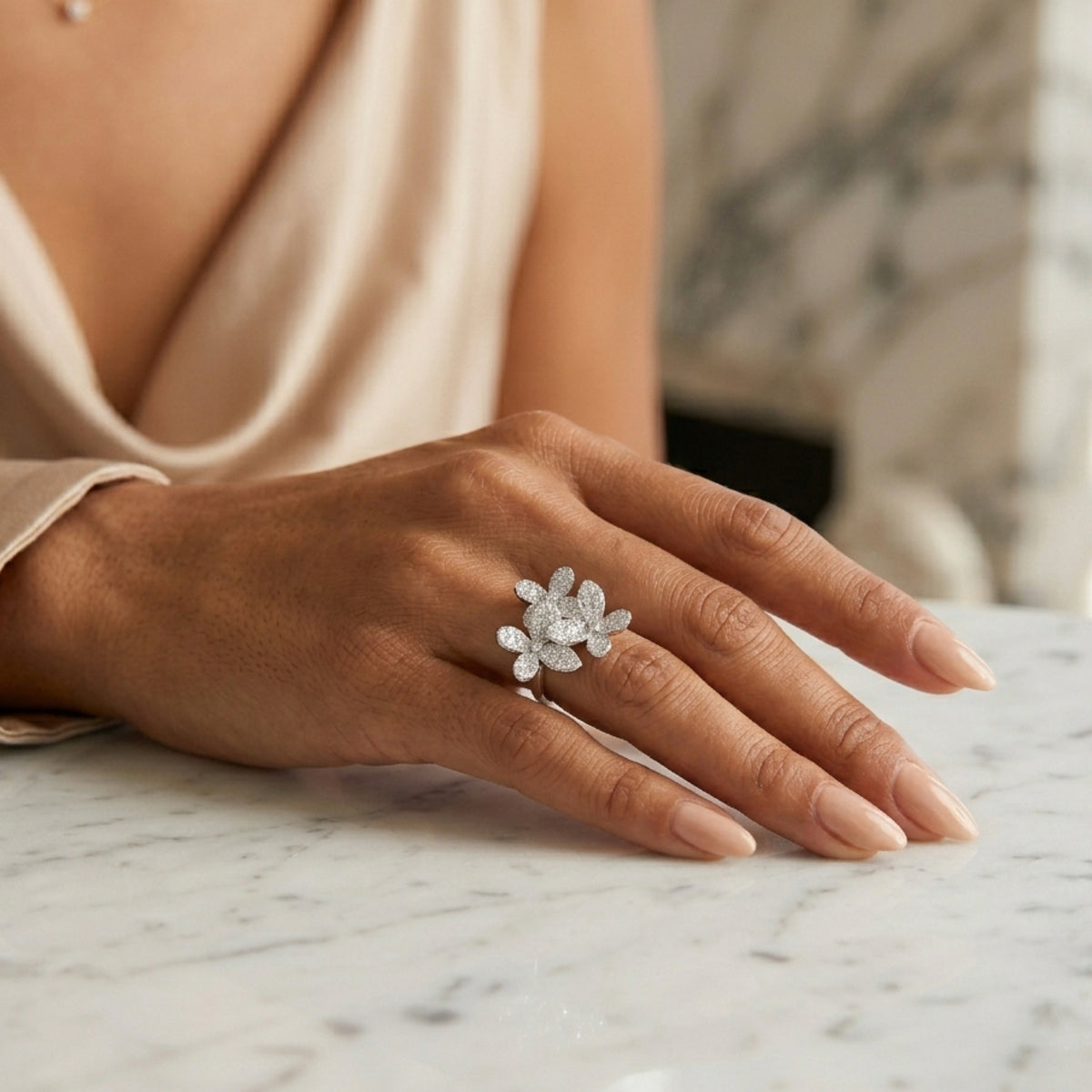 Hand wearing a diamond ring on a marble surface  Mariposa Pave Statement Ring - The Songbird Collection