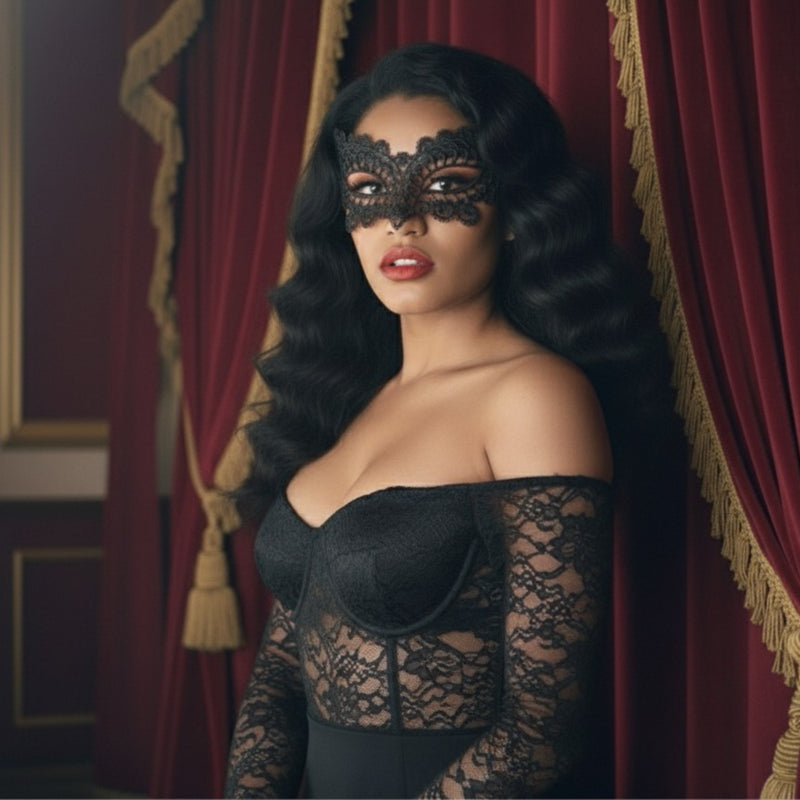 Woman wearing a black lace mask and dress in front of red curtains