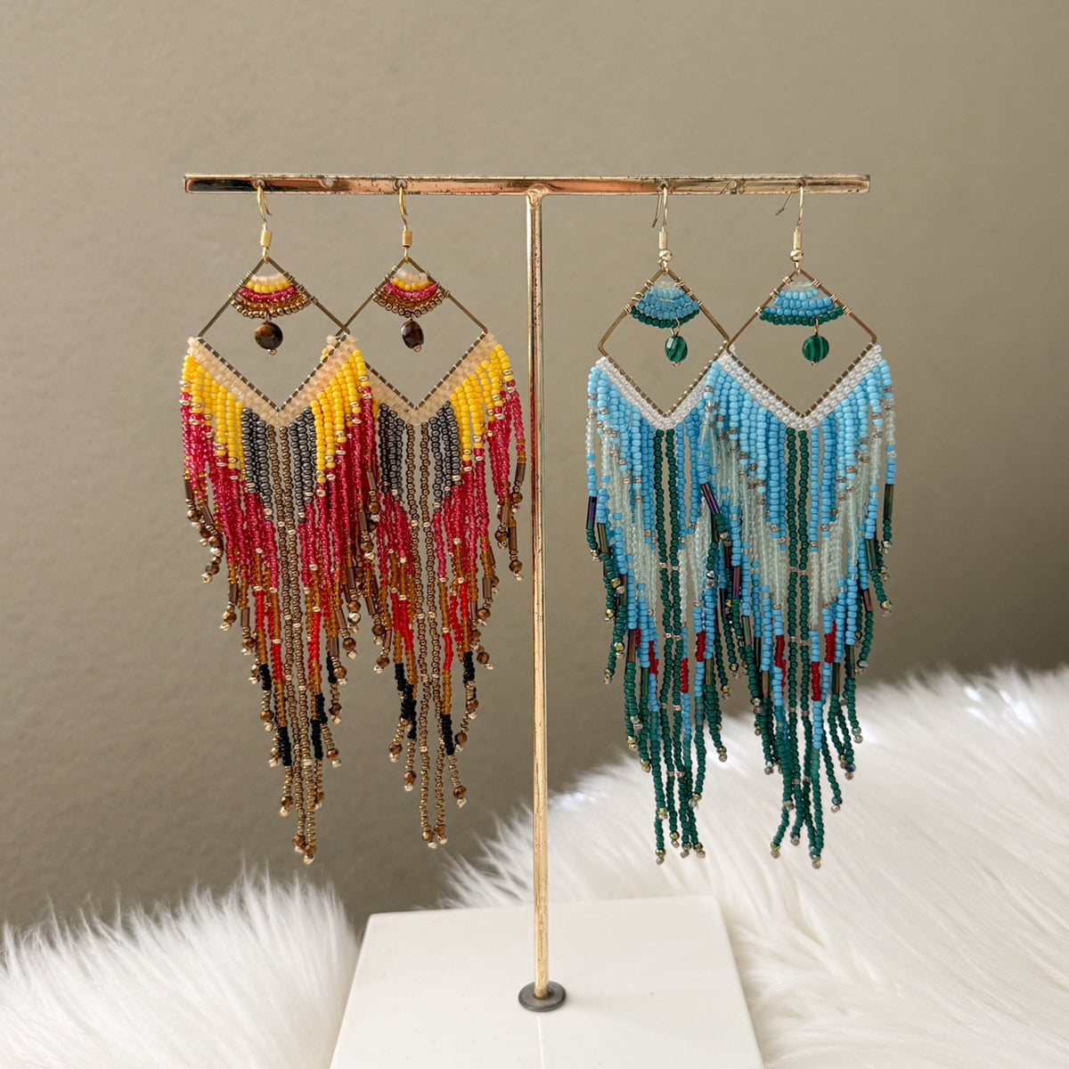 Pair of beaded earrings on a gold stand against a neutral background - Mojave Ombre Beaded Statement Earrings