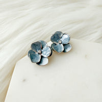 blue flower-shaped earrings with silver trimming on a white dish with gold rim - Moonlit Peony Earrings - The Songbird Collection