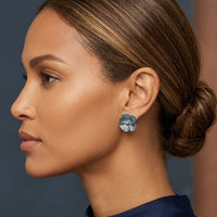 Woman wearing a floral earring with a blurred background
