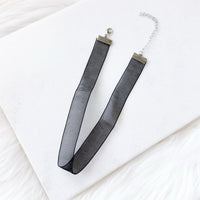 Black sheer ribbon necklace choker on a white background