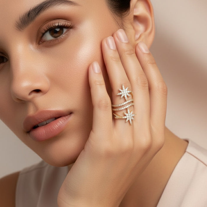 Woman wearing star-shaped diamond rings on a neutral background