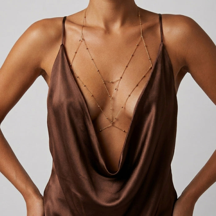 Brown satin dress with a deep neckline and thin straps on a neutral background Peek-a-boo Body Chains - The Songbird Collection 