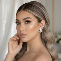 Woman wearing a floral diamond bridal earring with a blurred background