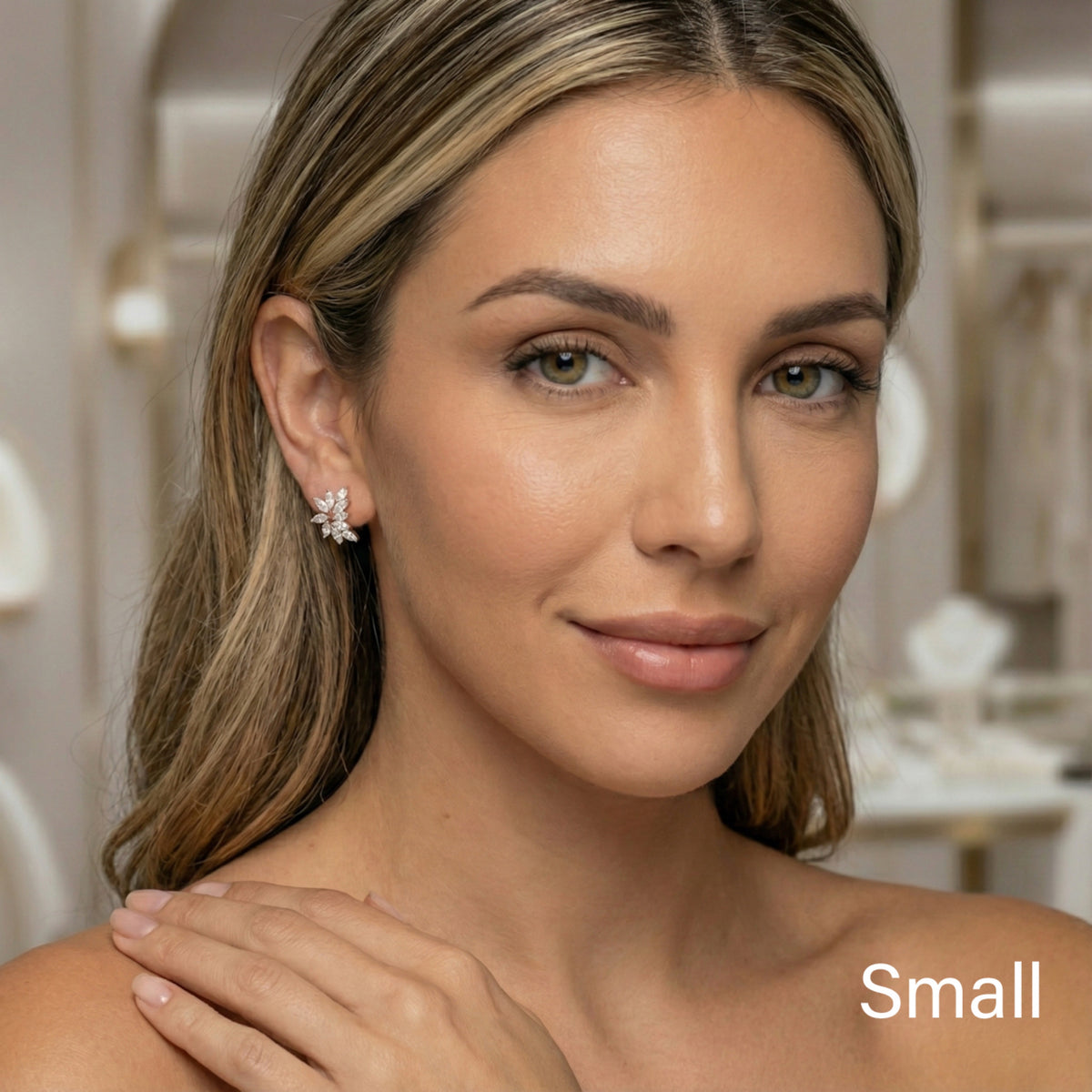 Woman wearing diamond earrings with a blurred background