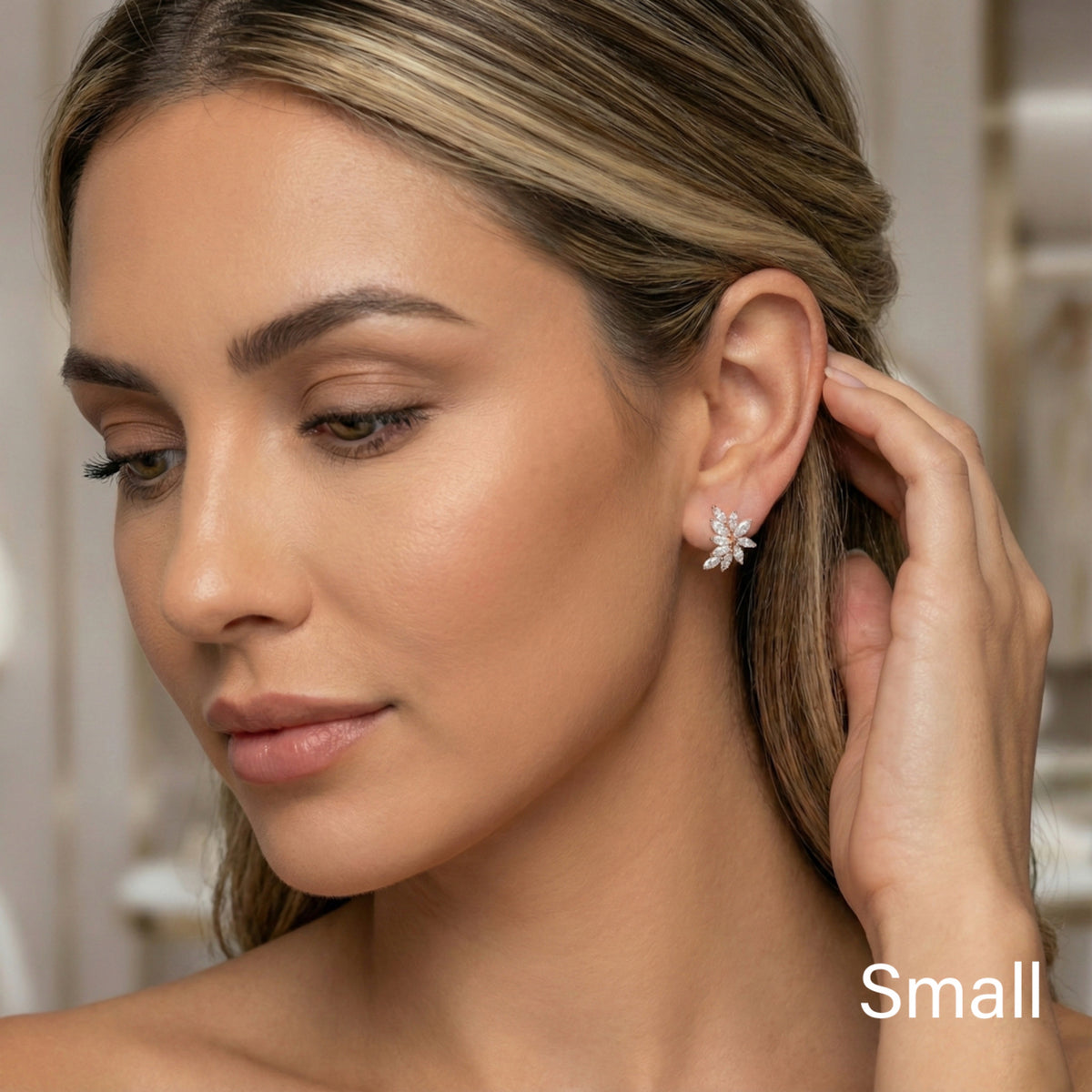 Woman wearing a small earring with a blurred background