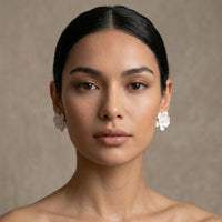 Woman wearing floral earrings against a neutral background. Rosalie Earrings - The Songbird Collection