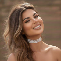 Woman wearing a delicate lace choker against a blurred natural background