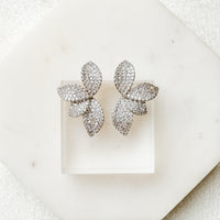 Pair of sparkling butterfly-shaped earrings on a white background. Seraphine Earrings - The Songbird Collection - pave - floral petal