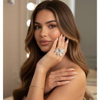 Woman wearing a petal/flora/butterfly-shaped wrap around ring 