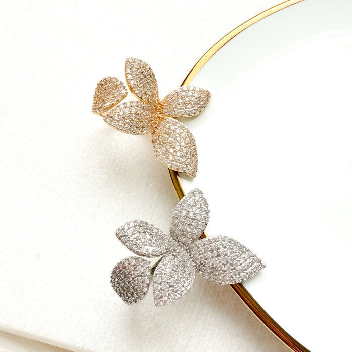 Gold and silver leaf-shapedwrap around ring on a white background