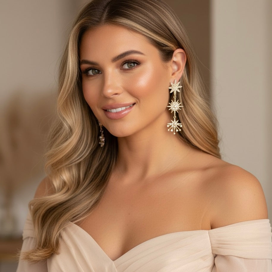 Woman wearing star-shaped earrings with a neutral background