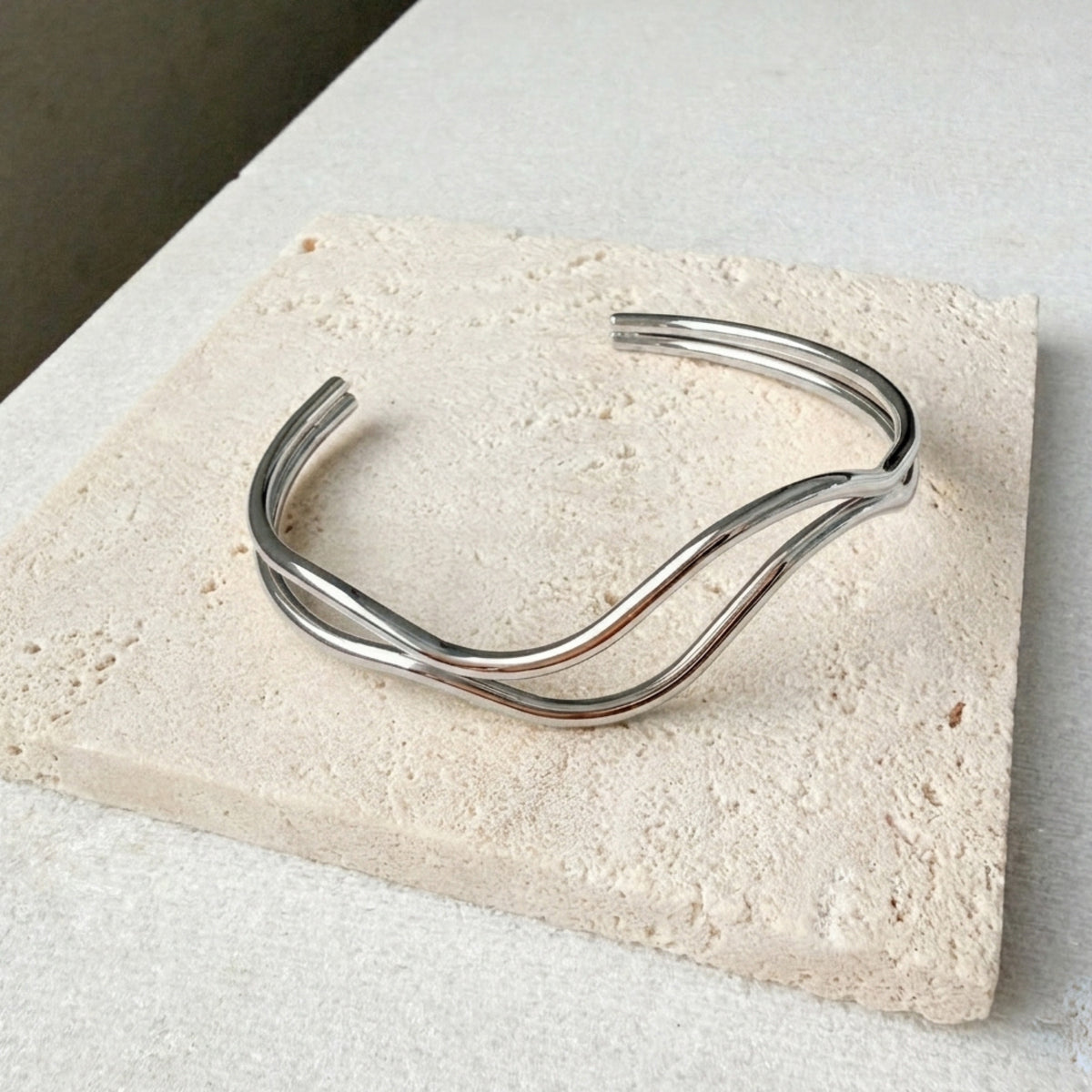 stainless steel  bracelet on a textured stone surface
