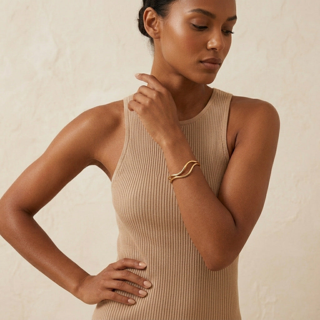 Woman wearing a beige ribbed tank top against a neutral background - The Contour Cuff Bracelet - The Songbird Collection
