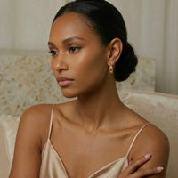 Woman wearing a beige satin dress with a neutral background - The Ever Teardrop Hoop Earrings - The Songbird Collection