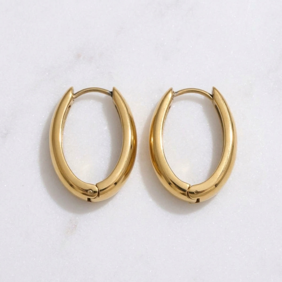 Gold hoop earrings on a light gray background - The Ever Teardrop Hoop Earrings - The Songbird Collection