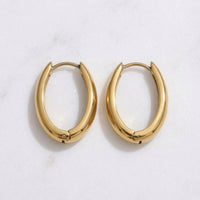 Gold hoop earrings on a light gray background - The Ever Teardrop Hoop Earrings - The Songbird Collection