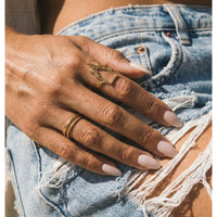 Hand with gold rings on a denim background  gothic_throne_ring - Tessa Ring Set- The Songbird Collection