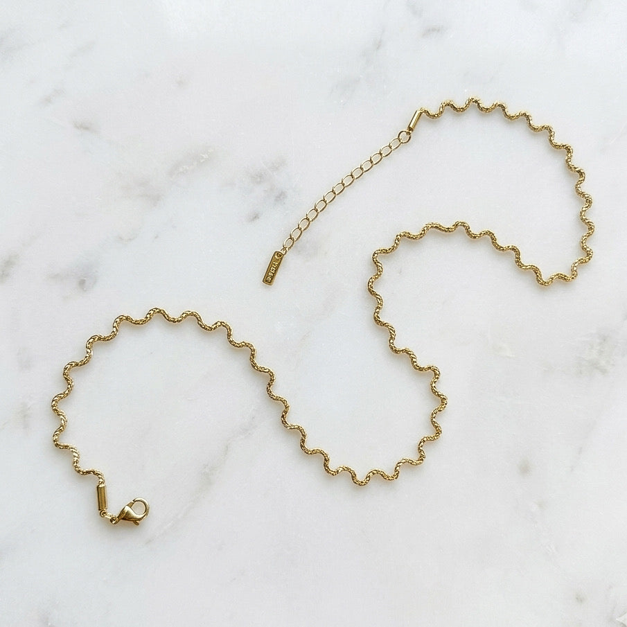 Gold chain necklace on a marble surface